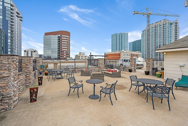 view of patio with a view of city, outdoor dining space, and outdoor lounge area