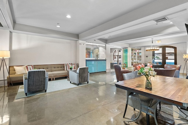 dining space with recessed lighting, a raised ceiling, visible vents, and finished concrete floors