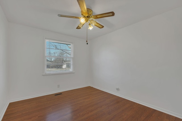 empty room featuring visible vents, ceiling fan, baseboards, and wood finished floors