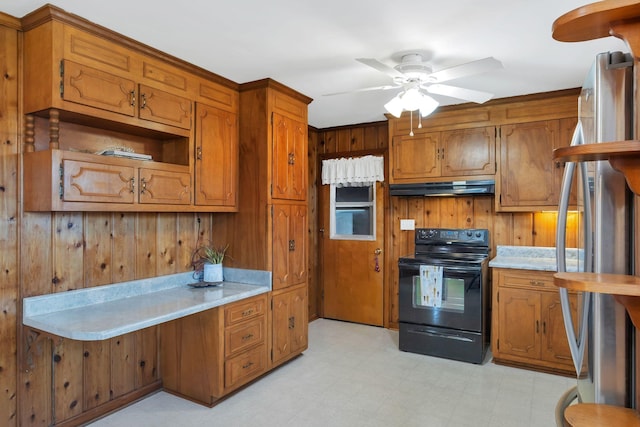 kitchen featuring brown cabinets, stainless steel refrigerator, light floors, under cabinet range hood, and black range with electric cooktop