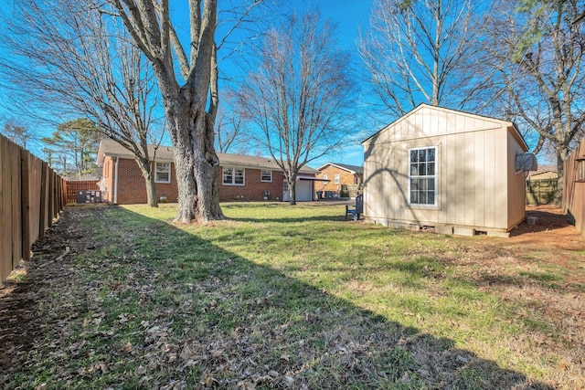 view of yard with a fenced backyard and an outdoor structure