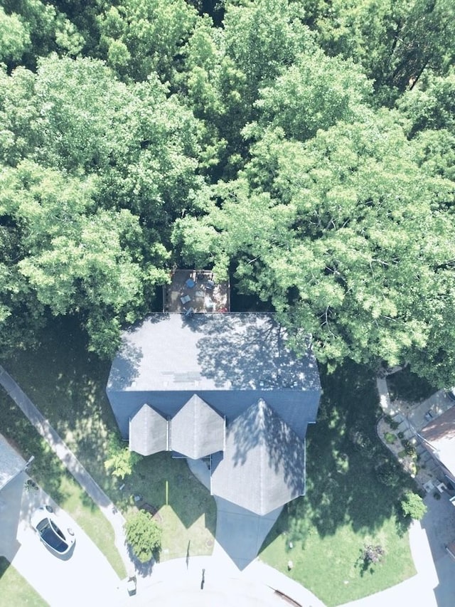 birds eye view of property with a view of trees