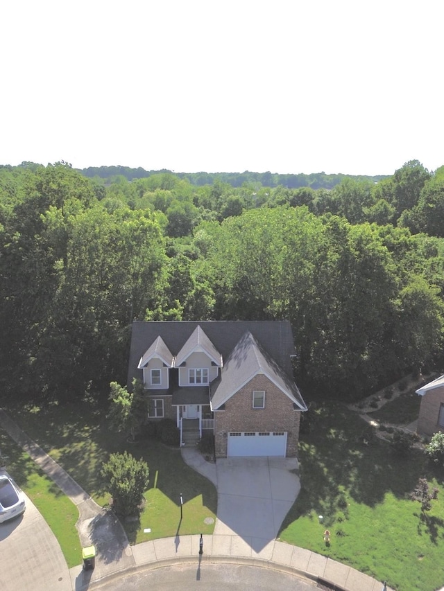 drone / aerial view featuring a forest view