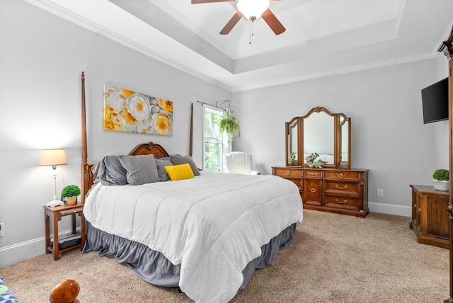 bedroom featuring baseboards, a tray ceiling, crown molding, and light colored carpet