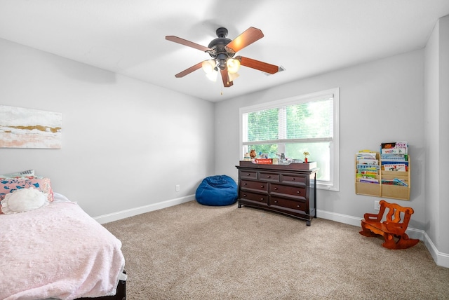 carpeted bedroom featuring ceiling fan and baseboards