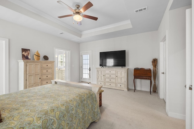 bedroom with baseboards, visible vents, a raised ceiling, and light colored carpet