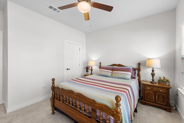 bedroom with baseboards, ceiling fan, visible vents, and light colored carpet