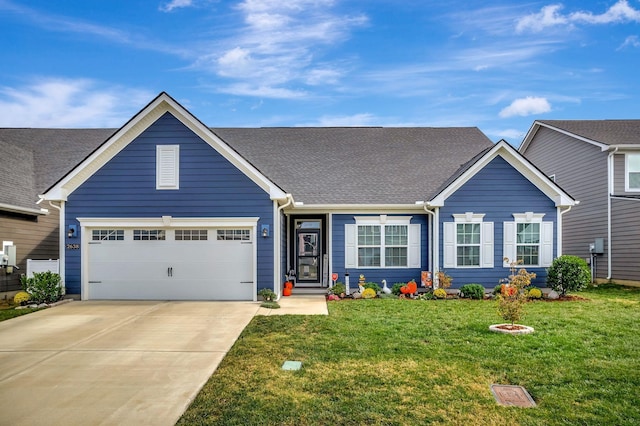 view of front of home featuring an attached garage, driveway, and a front yard