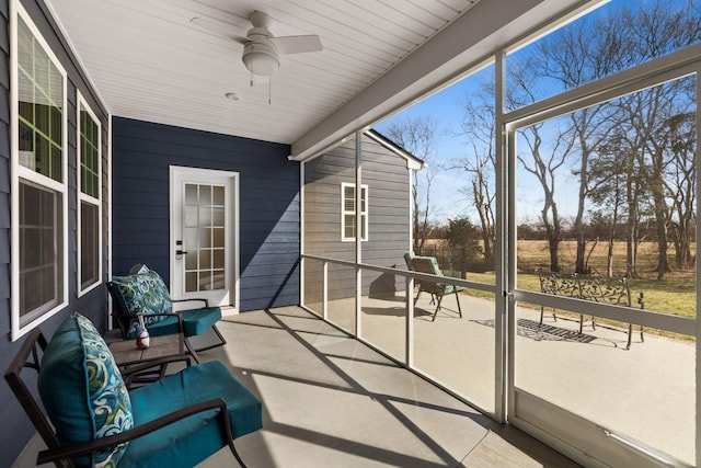 sunroom featuring ceiling fan