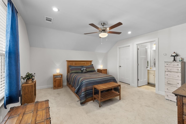 bedroom with light carpet, baseboards, and vaulted ceiling