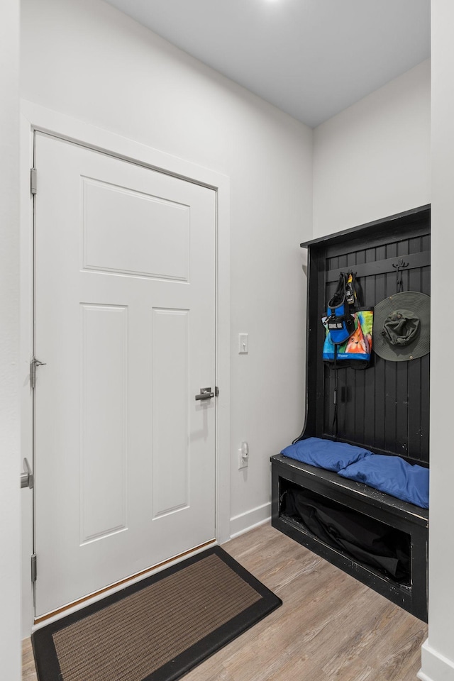 mudroom with wood finished floors and baseboards