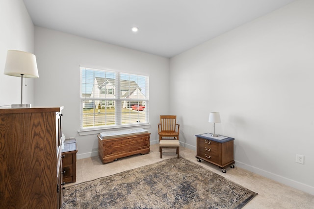 sitting room featuring carpet and baseboards