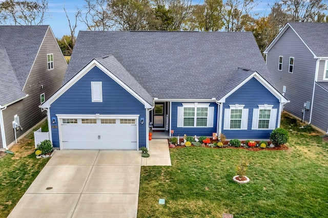 view of front of house featuring a front yard, roof with shingles, driveway, and an attached garage