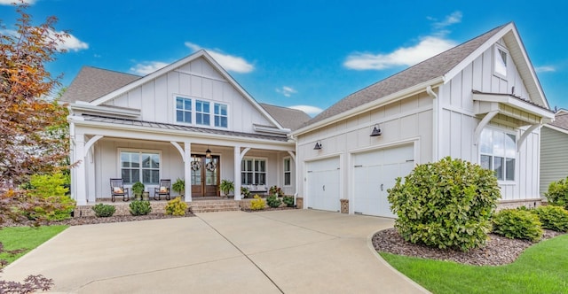 modern inspired farmhouse featuring roof with shingles, a porch, concrete driveway, board and batten siding, and a garage