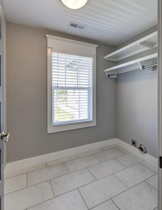 laundry area with laundry area, visible vents, hookup for an electric dryer, and marble finish floor