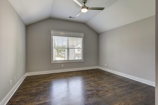 additional living space featuring visible vents, baseboards, vaulted ceiling, a ceiling fan, and dark wood finished floors