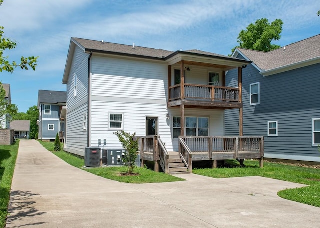 rear view of property featuring central air condition unit and a balcony