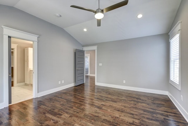 unfurnished bedroom with baseboards, vaulted ceiling, wood finished floors, and recessed lighting