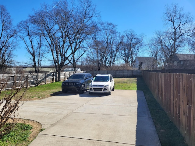 view of patio featuring driveway and a fenced backyard