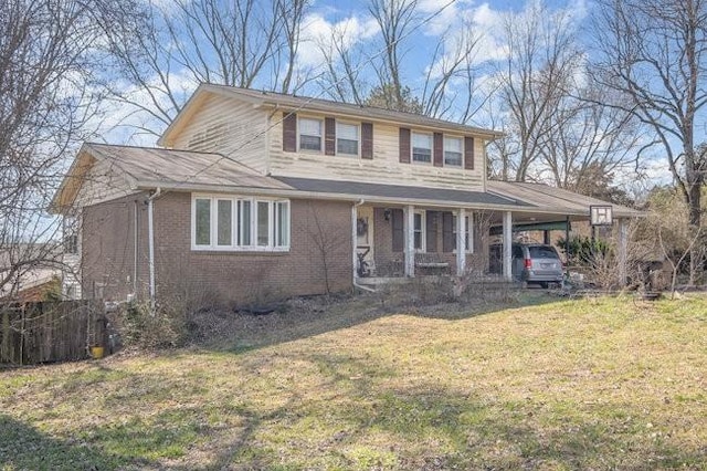 view of front facade with brick siding, a front lawn, and an attached carport