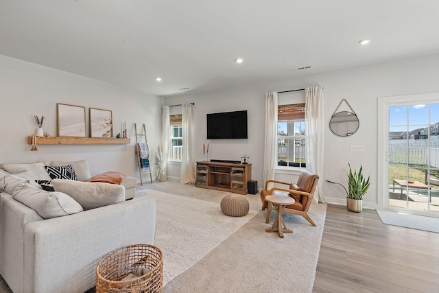 living room featuring light wood-style floors, a wealth of natural light, and recessed lighting