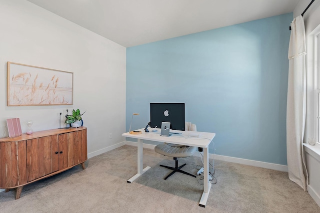 home office featuring baseboards and light colored carpet