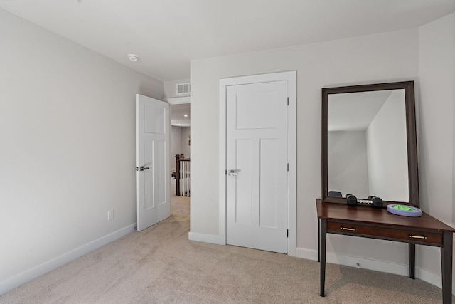 carpeted bedroom featuring visible vents and baseboards