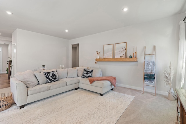 living room featuring light carpet, baseboards, and recessed lighting