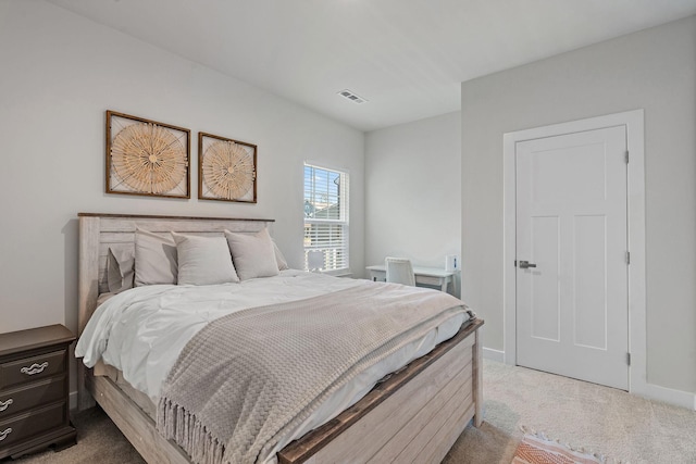 bedroom featuring baseboards, visible vents, and light colored carpet