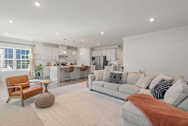 living room featuring recessed lighting and light wood-style flooring