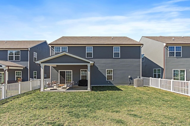 back of property featuring a patio area, central AC, a yard, and a fenced backyard