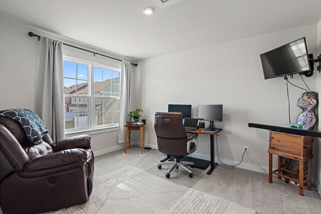 carpeted office space featuring baseboards