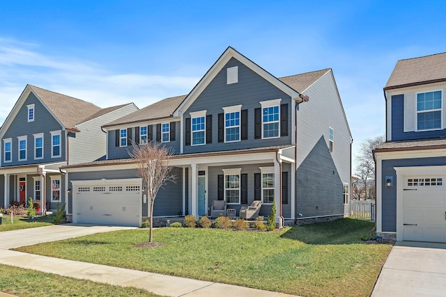 traditional-style house featuring a garage, a front yard, covered porch, and concrete driveway