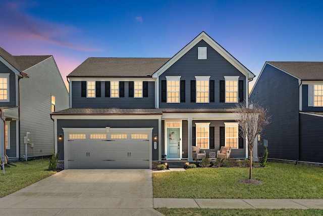 traditional-style house with a front lawn, covered porch, an attached garage, and concrete driveway