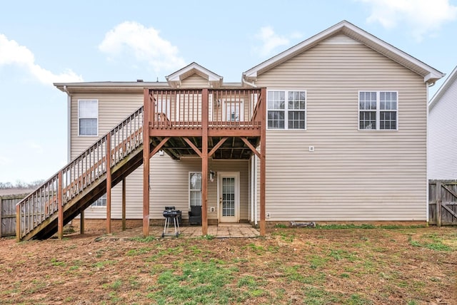 rear view of property featuring a patio, stairway, fence, and a wooden deck