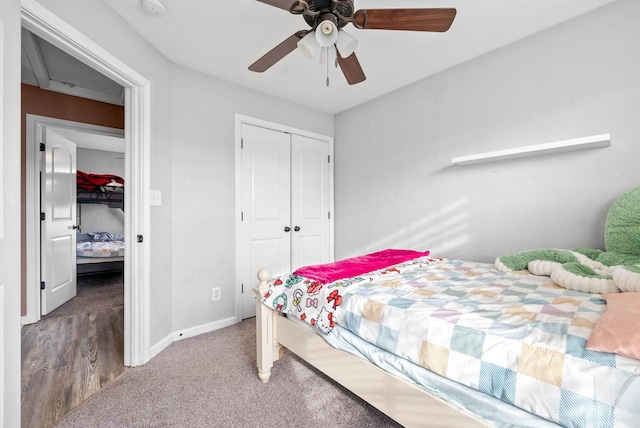 bedroom with carpet, a closet, ceiling fan, and baseboards