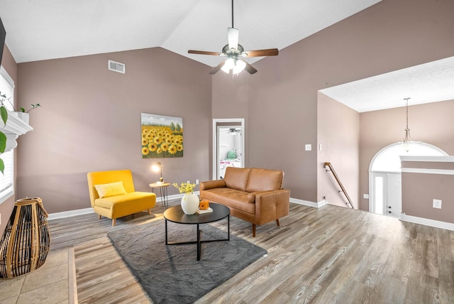 living room with visible vents, baseboards, and wood finished floors