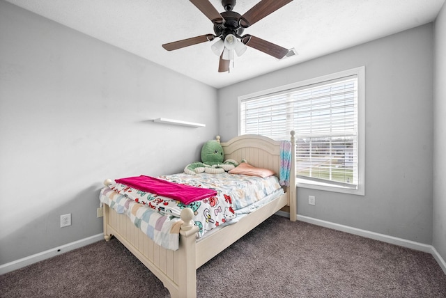 carpeted bedroom with visible vents, a ceiling fan, and baseboards