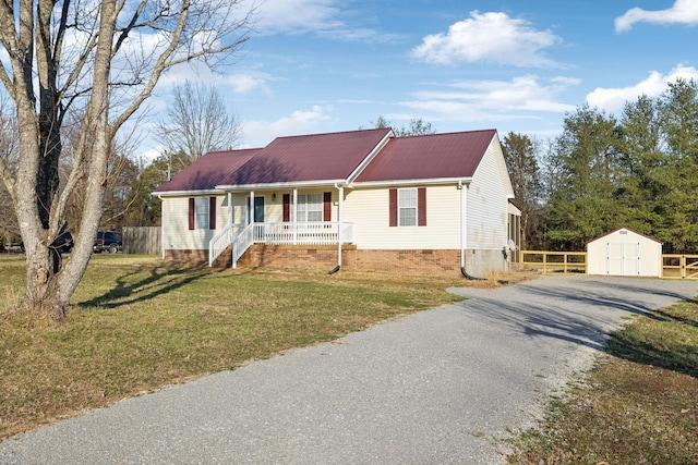 ranch-style house with crawl space, gravel driveway, a shed, a porch, and a front yard