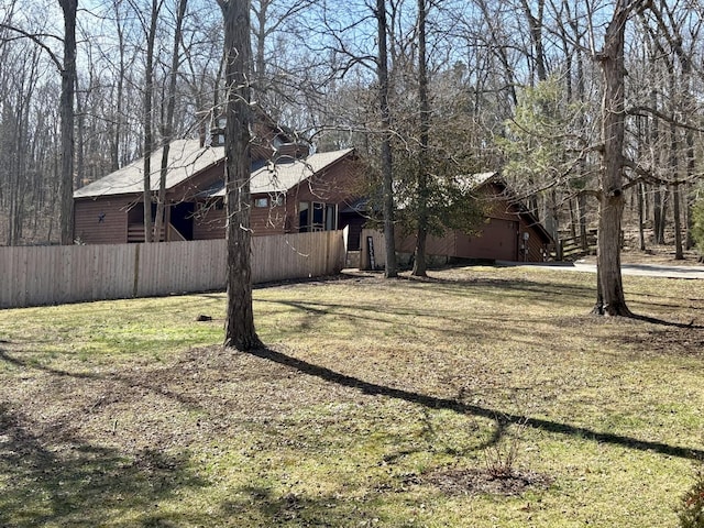 view of yard with a garage and fence