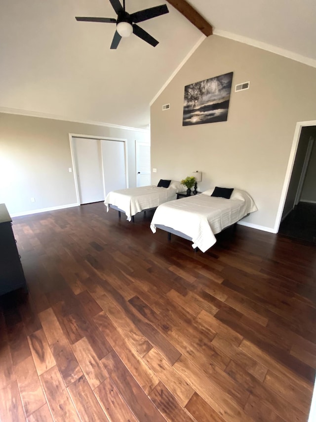 bedroom with baseboards, visible vents, lofted ceiling with beams, ceiling fan, and wood finished floors