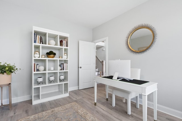 office space with wood finished floors and baseboards