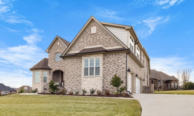 view of front of house with driveway, a shingled roof, a front yard, and brick siding