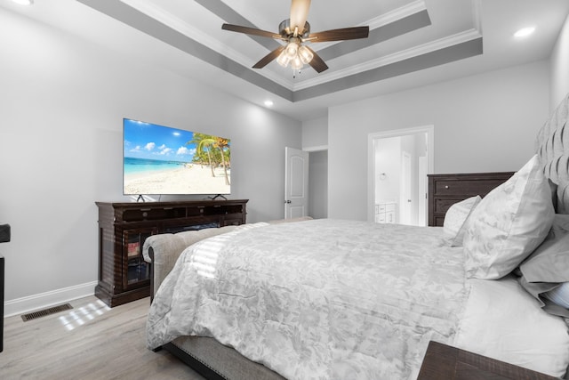 bedroom featuring visible vents, ornamental molding, a raised ceiling, and baseboards