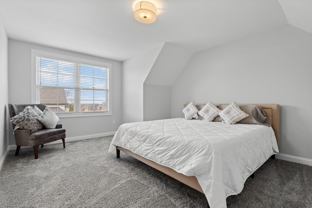 carpeted bedroom featuring vaulted ceiling and baseboards