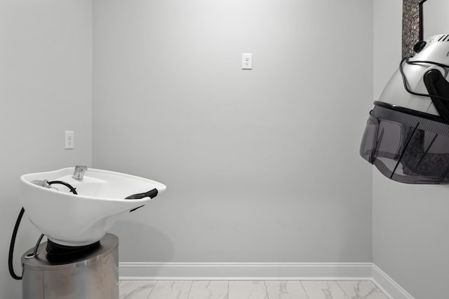 bathroom with marble finish floor and baseboards