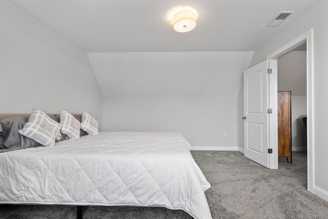 bedroom with lofted ceiling, baseboards, visible vents, and carpet flooring