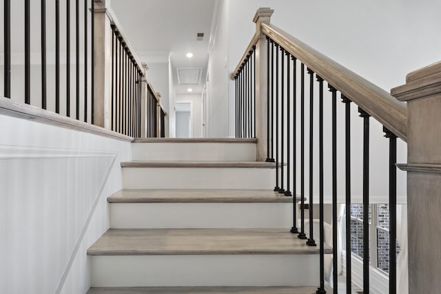 stairs featuring visible vents, ornamental molding, and recessed lighting