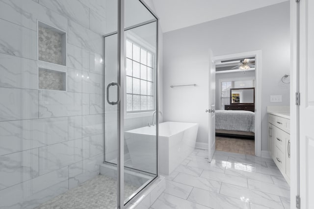 bathroom featuring marble finish floor, a soaking tub, ensuite bath, and a shower stall