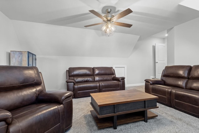 carpeted living room with baseboards, vaulted ceiling, and a ceiling fan